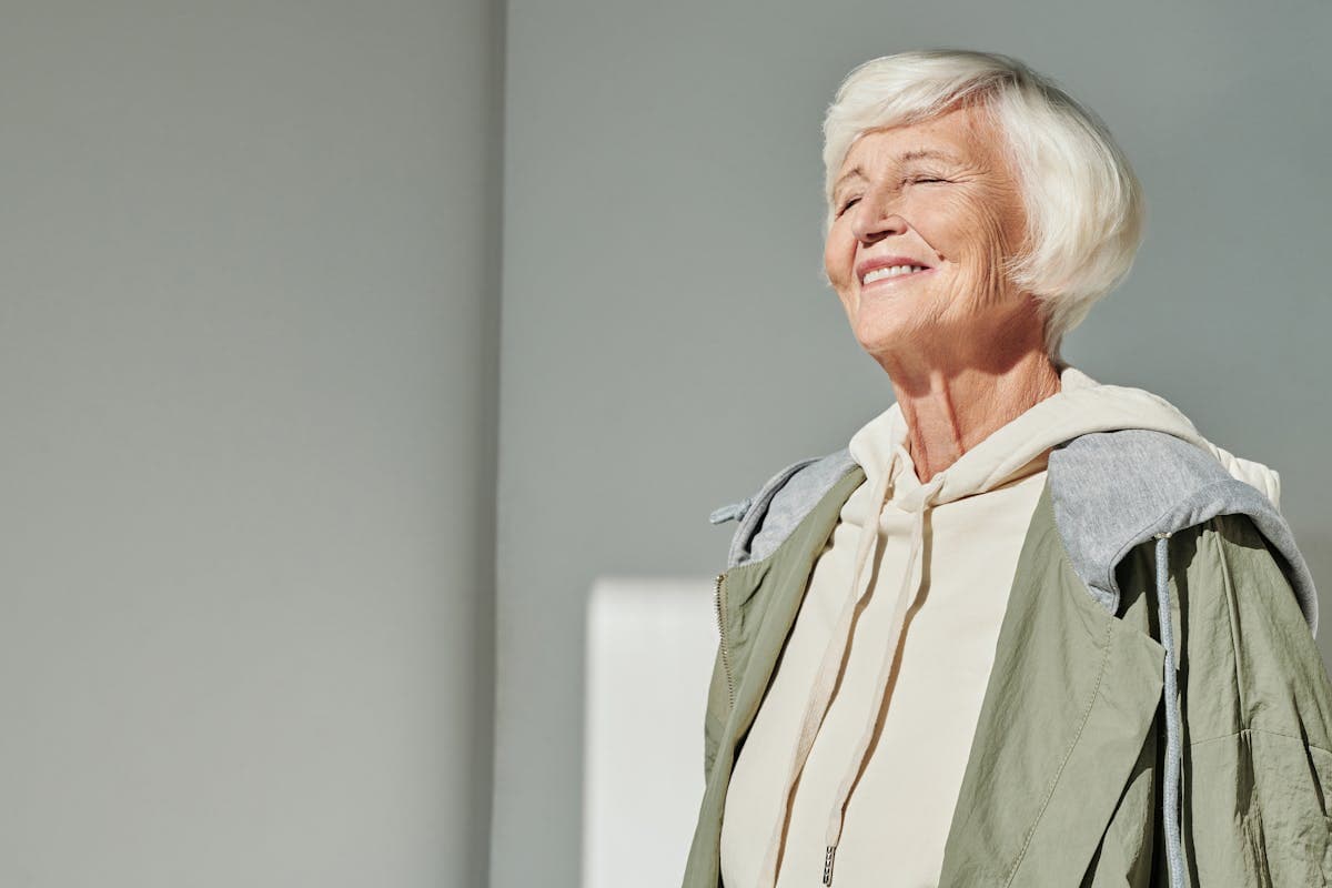 Senior woman smiling after All-On-4 dental implants in Mesa, AZ