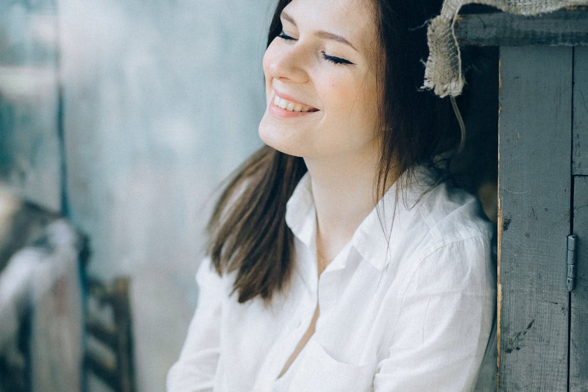 Relaxed woman smiling after TMJ treatment relief in Mesa, AZ