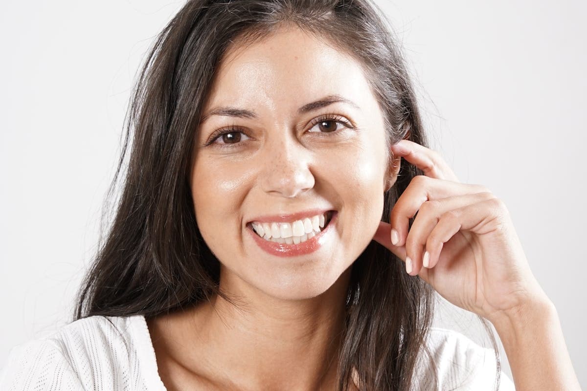 Woman with a bright, healthy smile considering dental implants vs dentures in Mesa, AZ