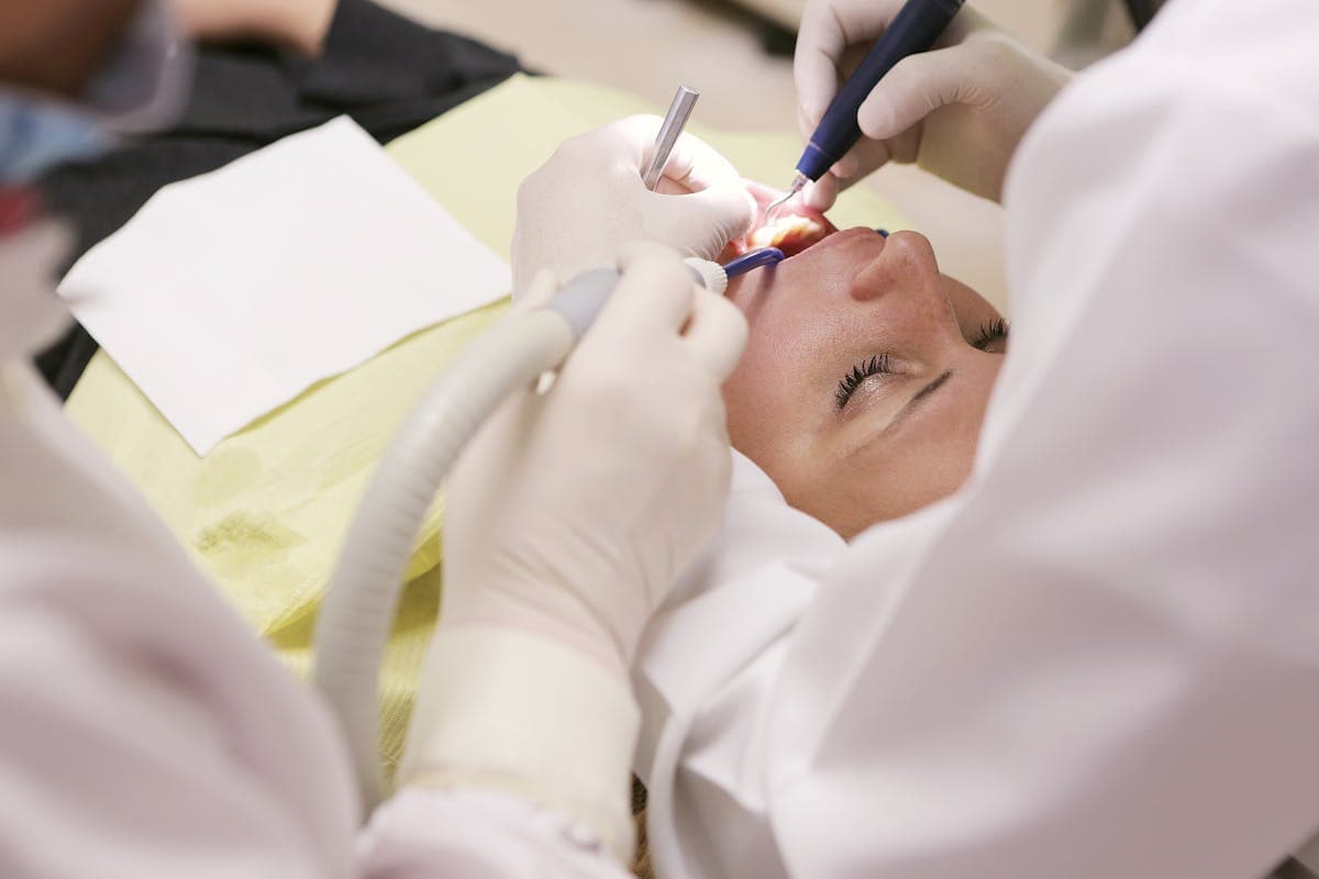 Woman in Mesa, AZ holding her jaw in pain from misdiagnosed TMJ disorder